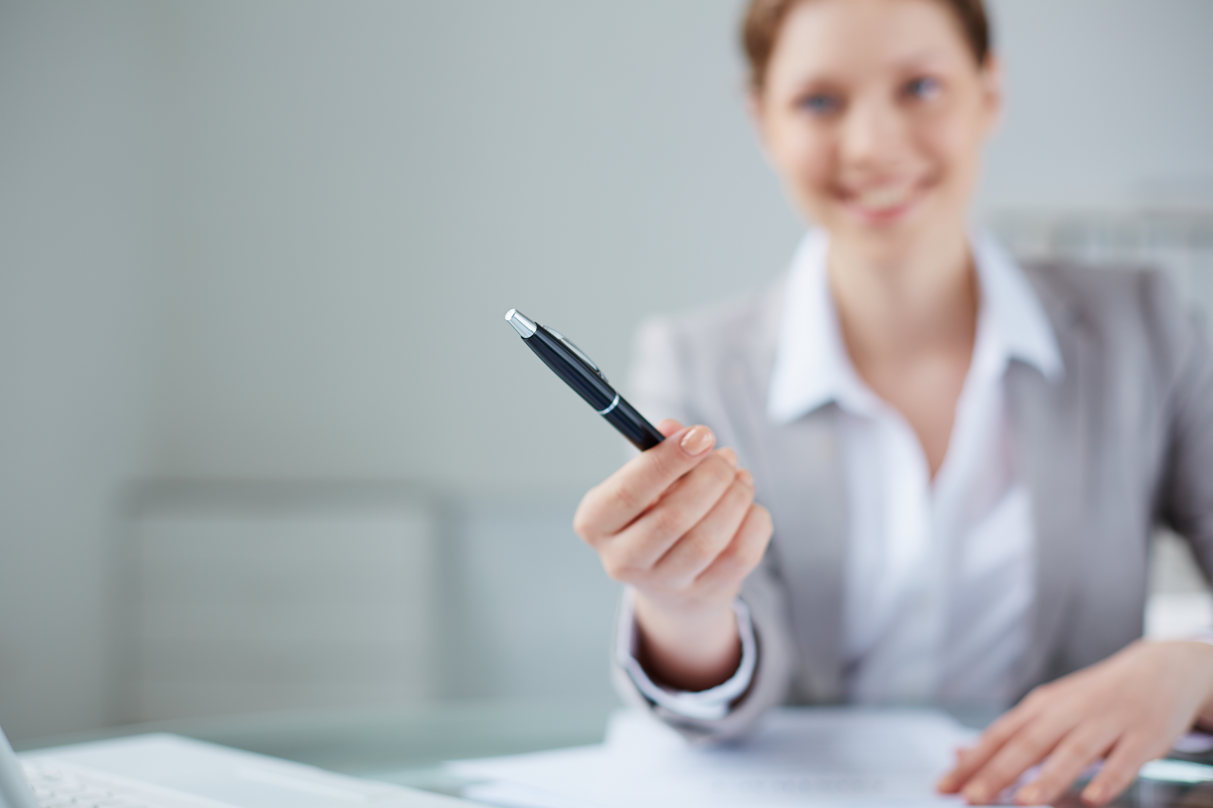 close-up-manager-holding-pen-with-blurred-background